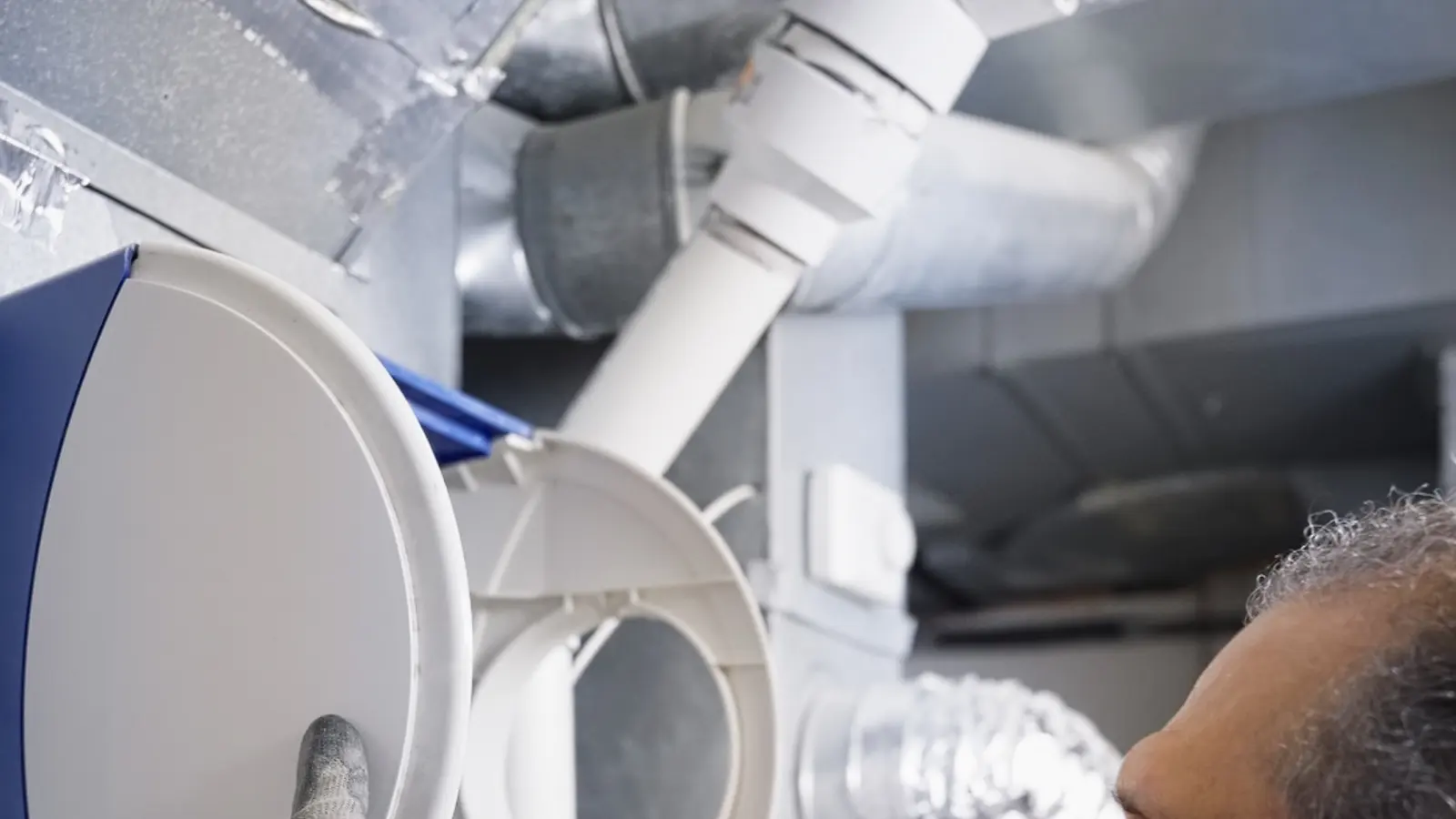 H&C technician working on home ductwork